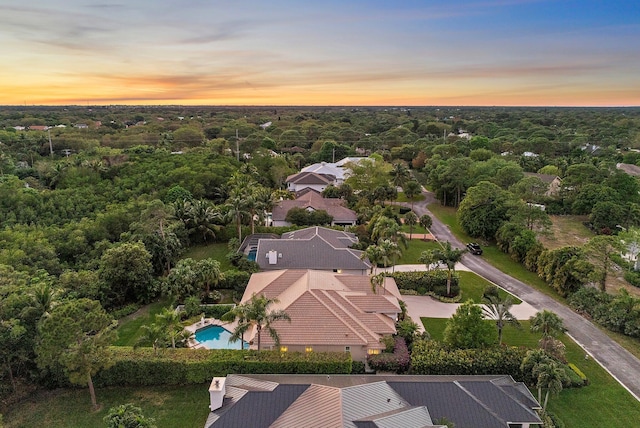 birds eye view of property with a forest view