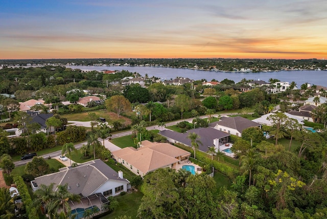 aerial view at dusk with a water view