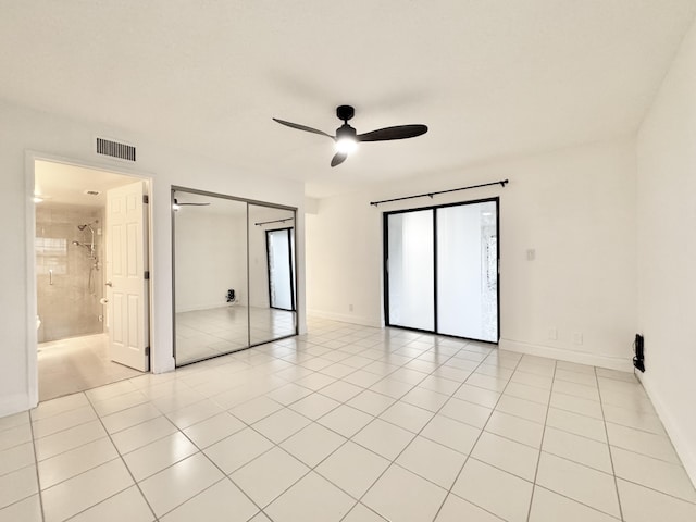 unfurnished bedroom featuring a ceiling fan, visible vents, baseboards, and light tile patterned flooring