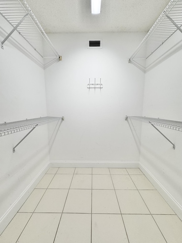 walk in closet featuring visible vents and light tile patterned floors