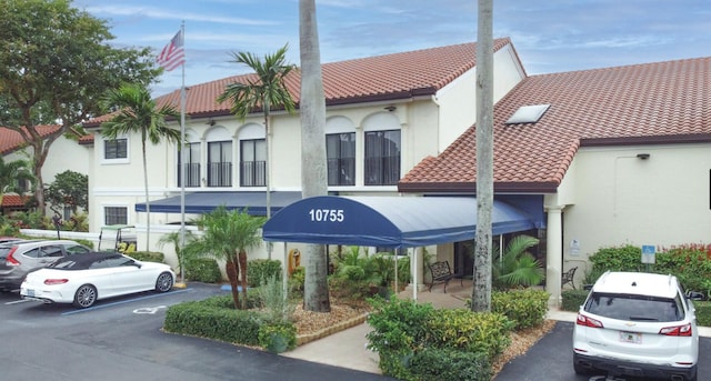 view of building exterior with uncovered parking