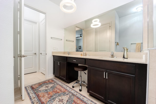 bathroom featuring tile patterned flooring, double vanity, and a sink