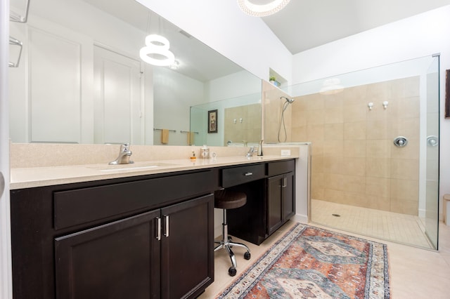 bathroom featuring a sink, double vanity, tile patterned flooring, and walk in shower