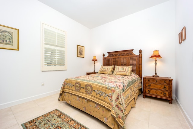 bedroom featuring light tile patterned floors and baseboards