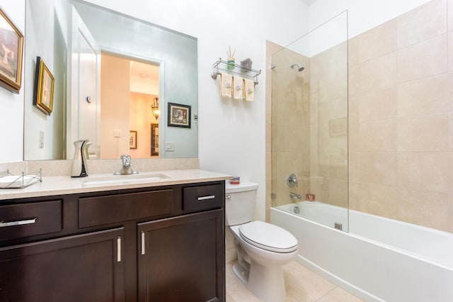 bathroom featuring tub / shower combination, toilet, vanity, and tile patterned flooring