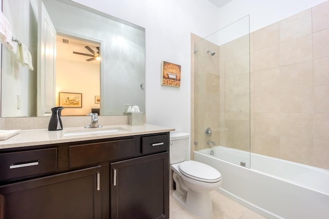 full bath with tile patterned floors, toilet, a ceiling fan, washtub / shower combination, and vanity