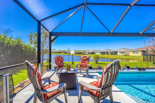 view of patio / terrace with an outdoor pool, a water view, and a lanai