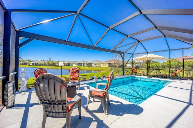 pool featuring a lanai, a patio, and a water view