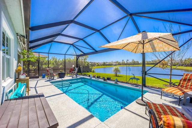 pool with glass enclosure, a patio, a yard, and a water view