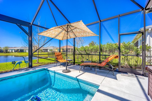 outdoor pool featuring a water view, fence, a lanai, and a patio area