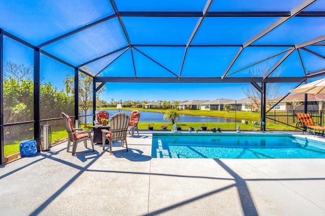 view of pool with a fenced in pool, glass enclosure, a patio, and a water view