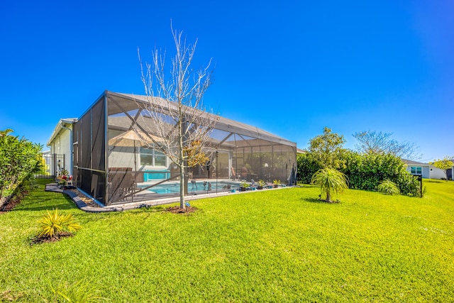 view of yard featuring glass enclosure and an outdoor pool