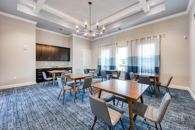 dining area featuring a notable chandelier, a tray ceiling, baseboards, and a towering ceiling