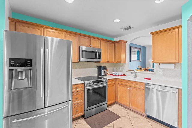 kitchen with light countertops, appliances with stainless steel finishes, light tile patterned flooring, and visible vents