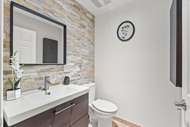 bathroom with tile patterned flooring, visible vents, vanity, and toilet