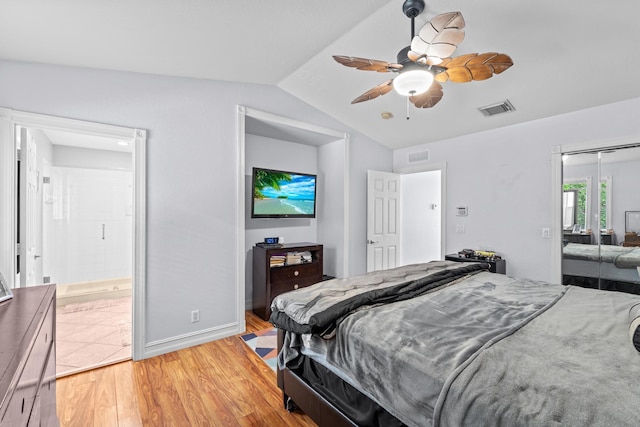 bedroom with lofted ceiling, light wood finished floors, a closet, and visible vents