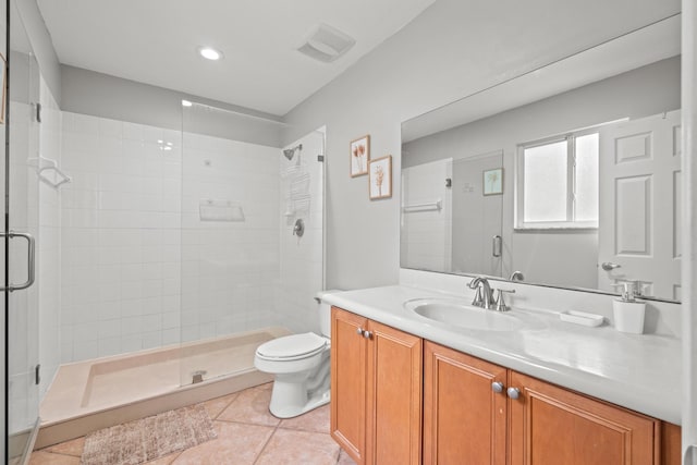 bathroom featuring tile patterned flooring, toilet, visible vents, vanity, and a stall shower