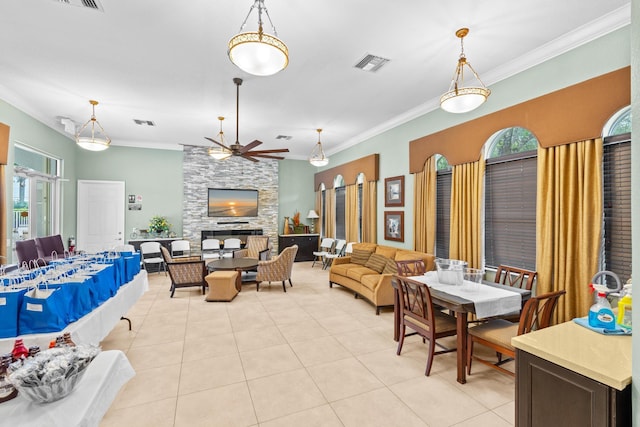 dining area with a wealth of natural light, visible vents, and crown molding