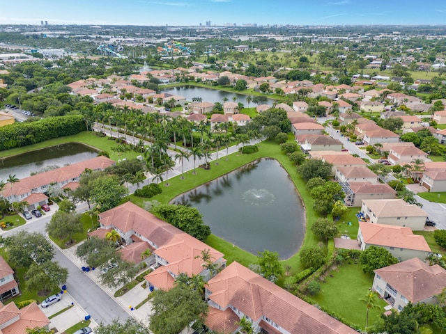 drone / aerial view featuring a residential view and a water view