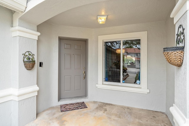 entrance to property with stucco siding