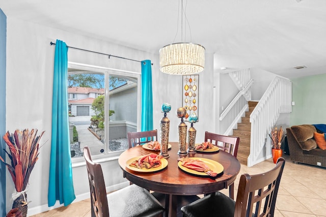 dining space with stairs, light tile patterned flooring, baseboards, and a notable chandelier