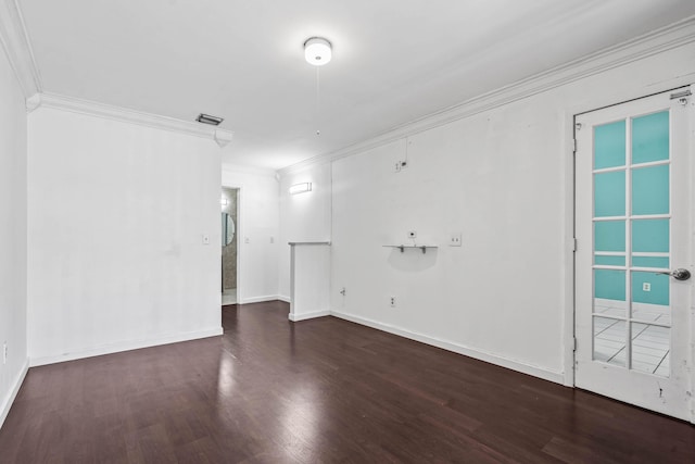 unfurnished room featuring ornamental molding, wood finished floors, visible vents, and baseboards