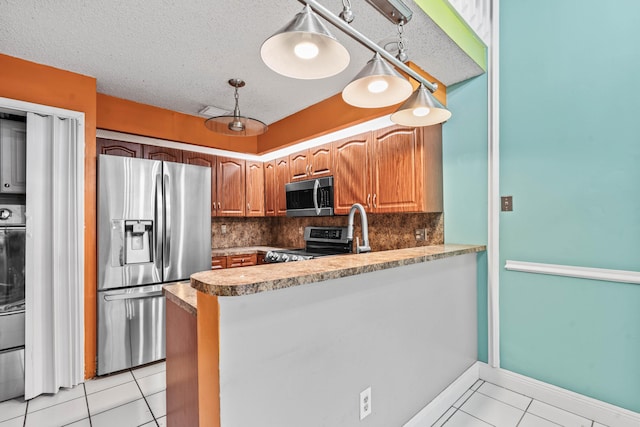 kitchen with light tile patterned floors, a textured ceiling, stainless steel appliances, and backsplash