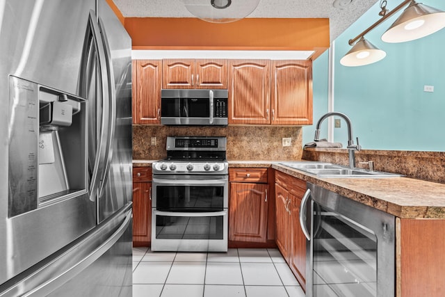 kitchen featuring a textured ceiling, wine cooler, a sink, appliances with stainless steel finishes, and decorative backsplash