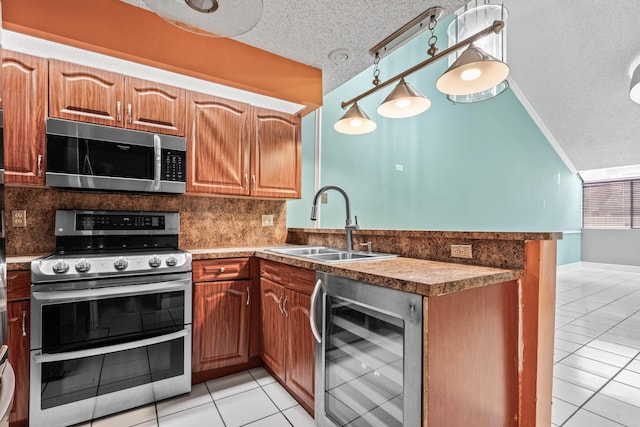 kitchen featuring lofted ceiling, wine cooler, appliances with stainless steel finishes, and a sink