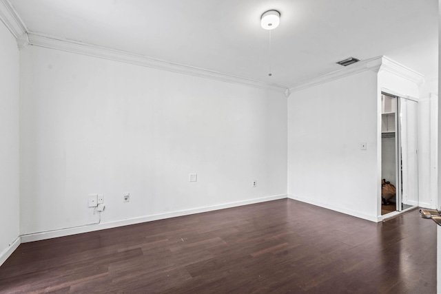 interior space with baseboards, wood finished floors, and crown molding