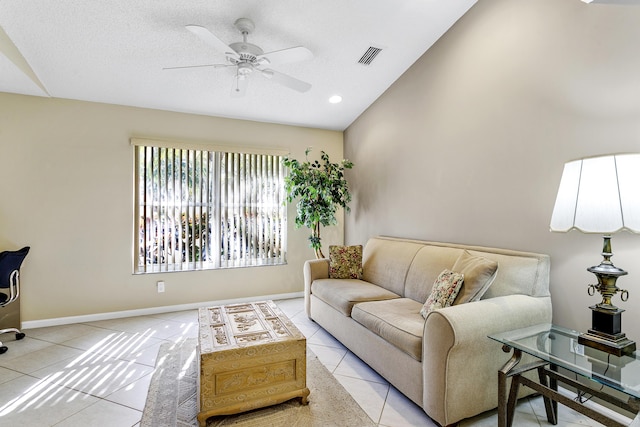 living room featuring tile patterned flooring, vaulted ceiling, ceiling fan, and baseboards