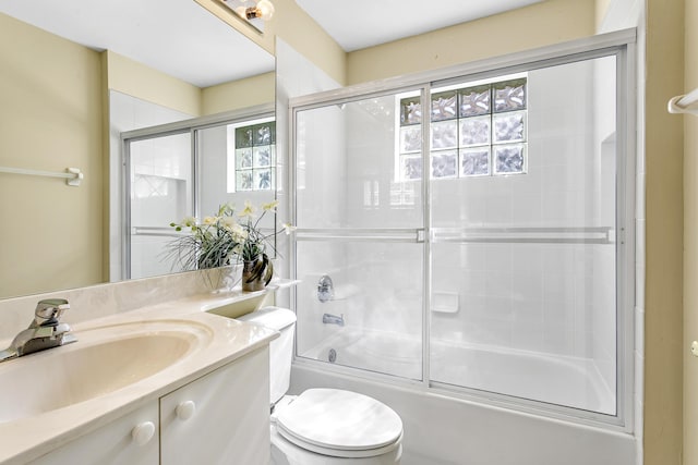 full bathroom featuring toilet, shower / bath combination with glass door, and vanity