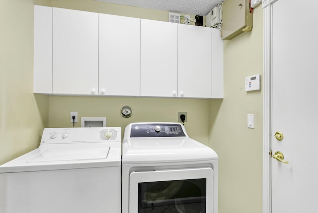 laundry room with cabinet space and washing machine and clothes dryer