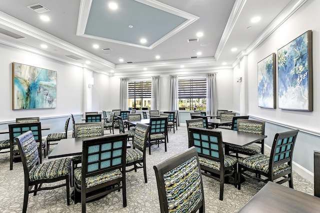 carpeted dining space featuring a tray ceiling, crown molding, recessed lighting, visible vents, and baseboards