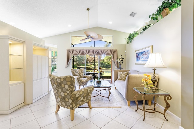 living area with a ceiling fan, lofted ceiling, visible vents, and light tile patterned floors