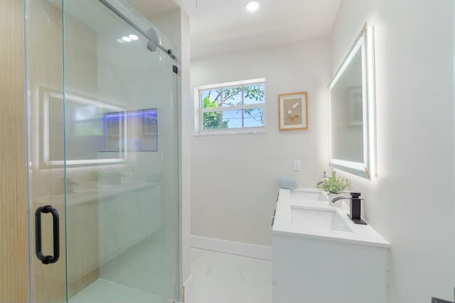 bathroom featuring baseboards, marble finish floor, a sink, and a shower stall