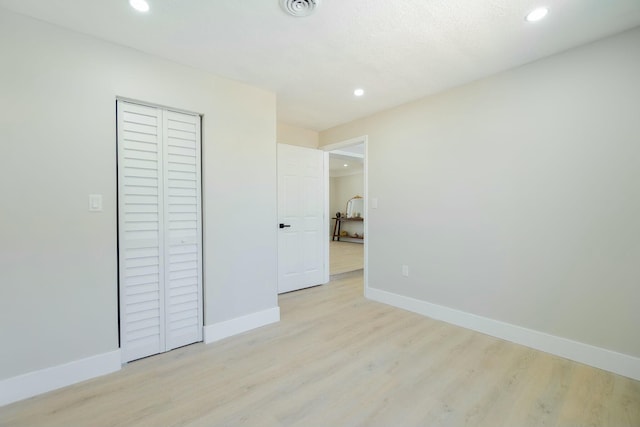 unfurnished bedroom featuring light wood-style floors, recessed lighting, and baseboards