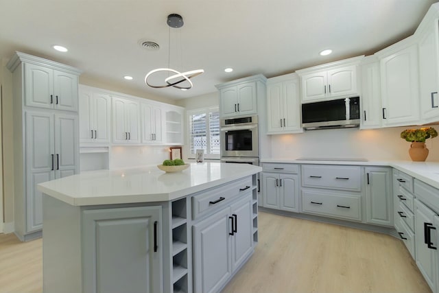 kitchen featuring open shelves, stainless steel appliances, light wood-style flooring, white cabinets, and a kitchen island