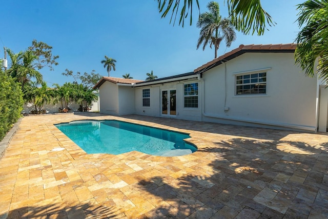 view of swimming pool with a fenced in pool, french doors, a patio, and fence