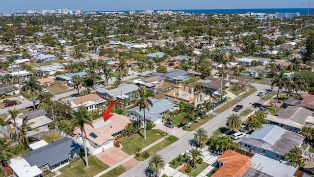 drone / aerial view with a water view and a residential view