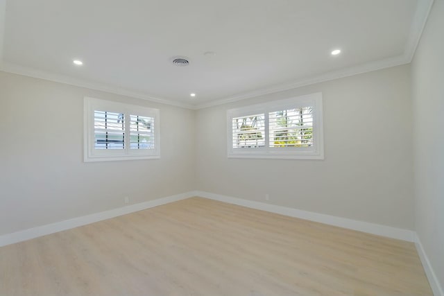 empty room with ornamental molding, plenty of natural light, and baseboards