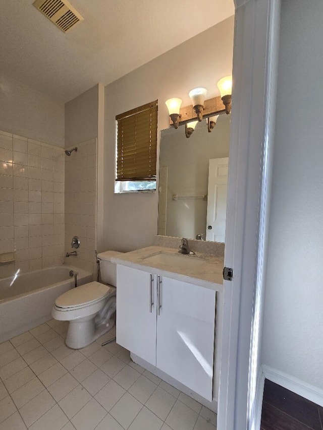 full bath featuring toilet, vanity, visible vents, shower / washtub combination, and tile patterned floors