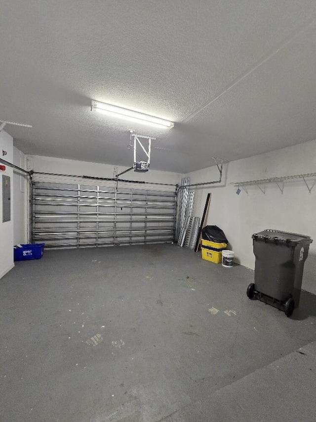 garage featuring electric panel and a garage door opener