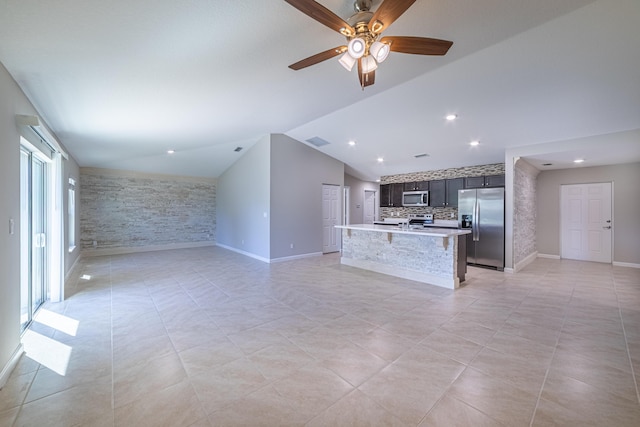 unfurnished living room featuring ceiling fan, light tile patterned floors, visible vents, baseboards, and vaulted ceiling