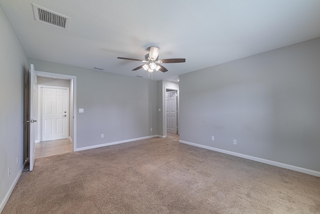 unfurnished room featuring a ceiling fan, baseboards, visible vents, and carpet flooring