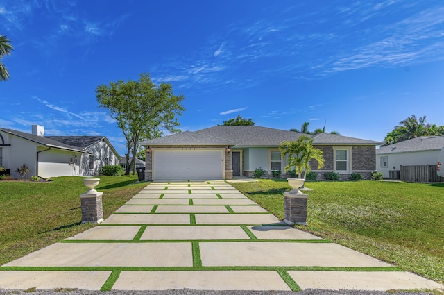 single story home with stucco siding, an attached garage, driveway, and a front yard