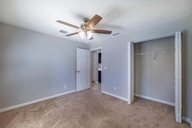 unfurnished bedroom with a closet, visible vents, baseboards, and carpet flooring