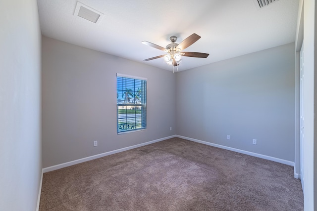 carpeted spare room featuring ceiling fan, visible vents, and baseboards