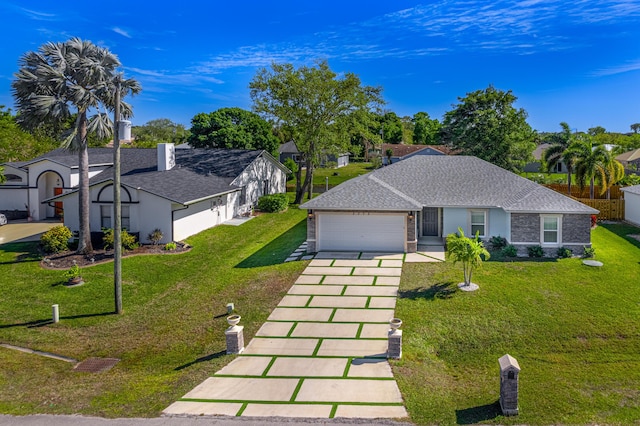 ranch-style house featuring a shingled roof, a garage, driveway, and a front lawn