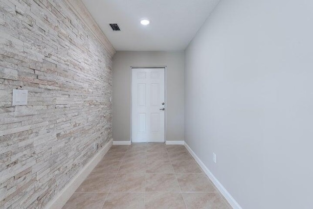 unfurnished room with light tile patterned floors, visible vents, and baseboards